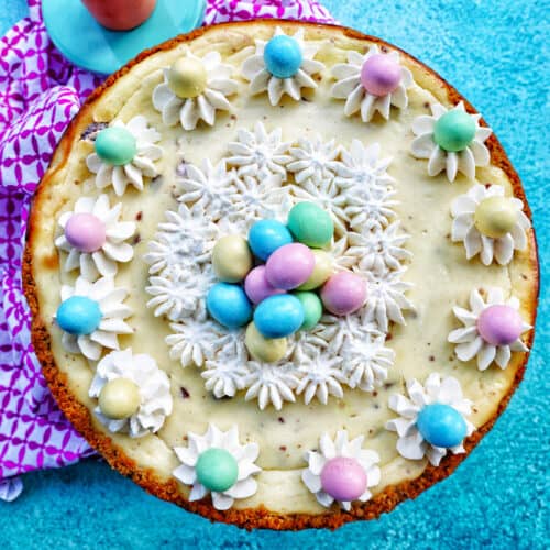 easter egg cheesecake with whipped cream and mini chocolate eggs.
