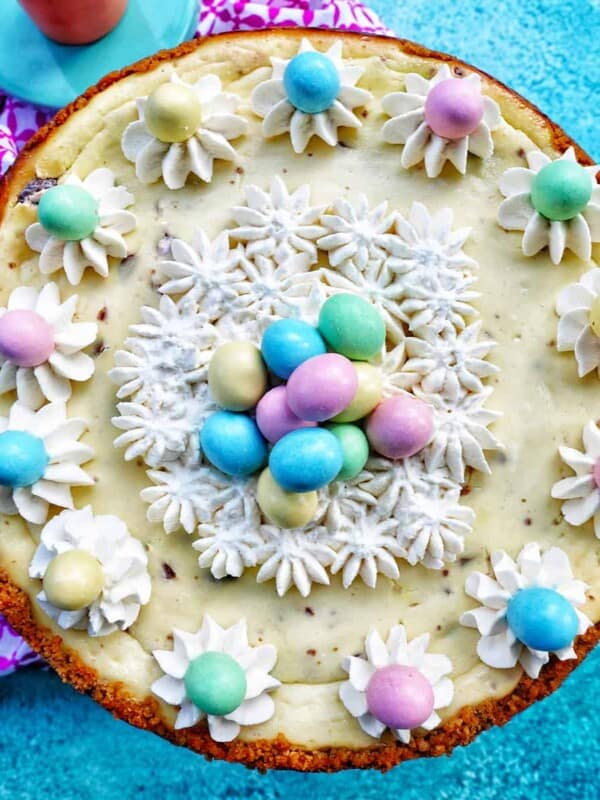 easter egg cheesecake with whipped cream and mini chocolate eggs.