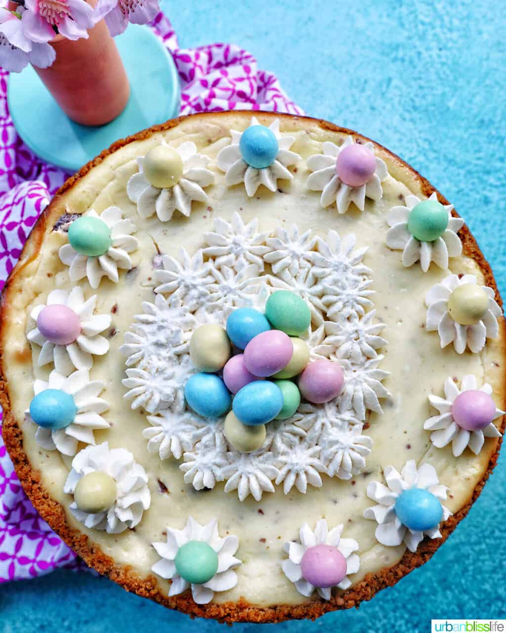 easter egg cheesecake with mini chocolate eggs and whipped cream.