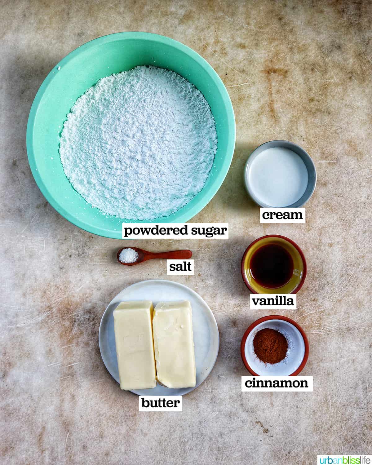 bowls of ingredients to make cinnamon buttercream frosting.