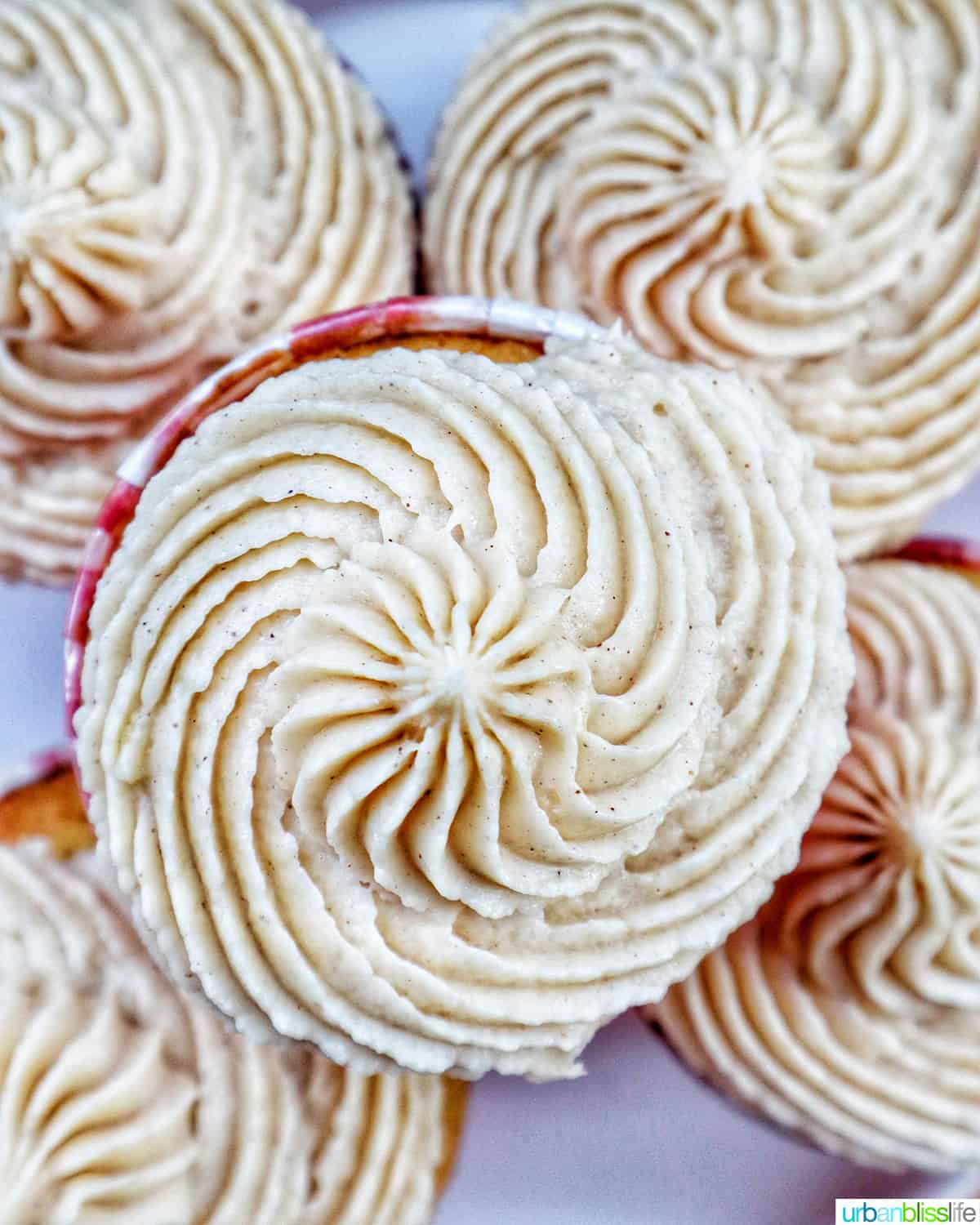 closeup of swirled buttercream frosting on top of cupcakes.
