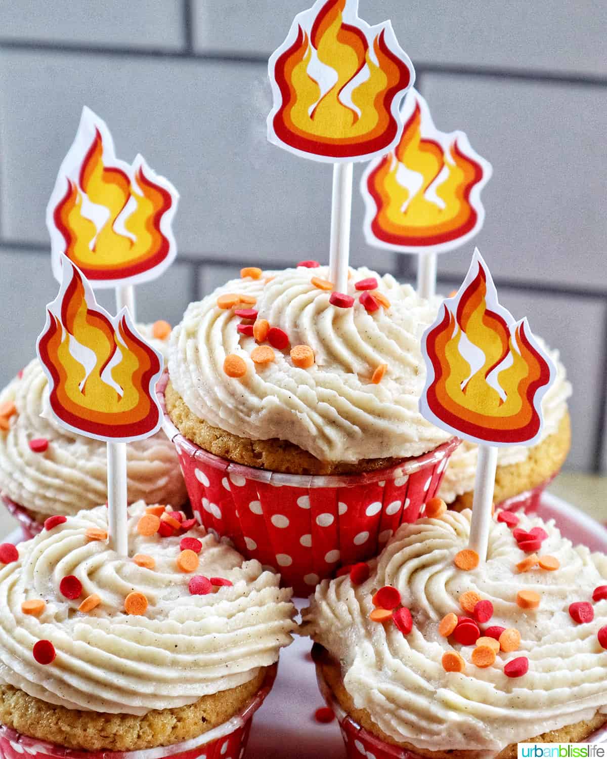 stack of fireball cupcakes with sprinkles and fire cupcake sticks.