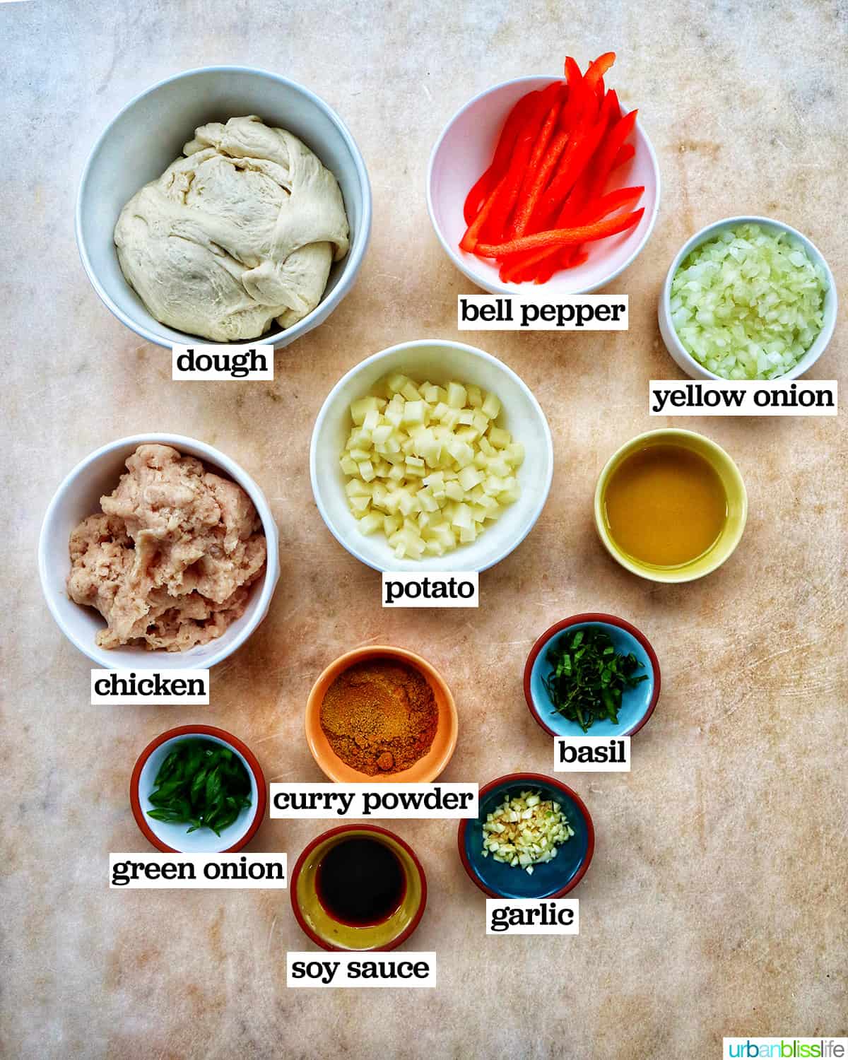 bowls of ingredients to make Thai curry pizza.