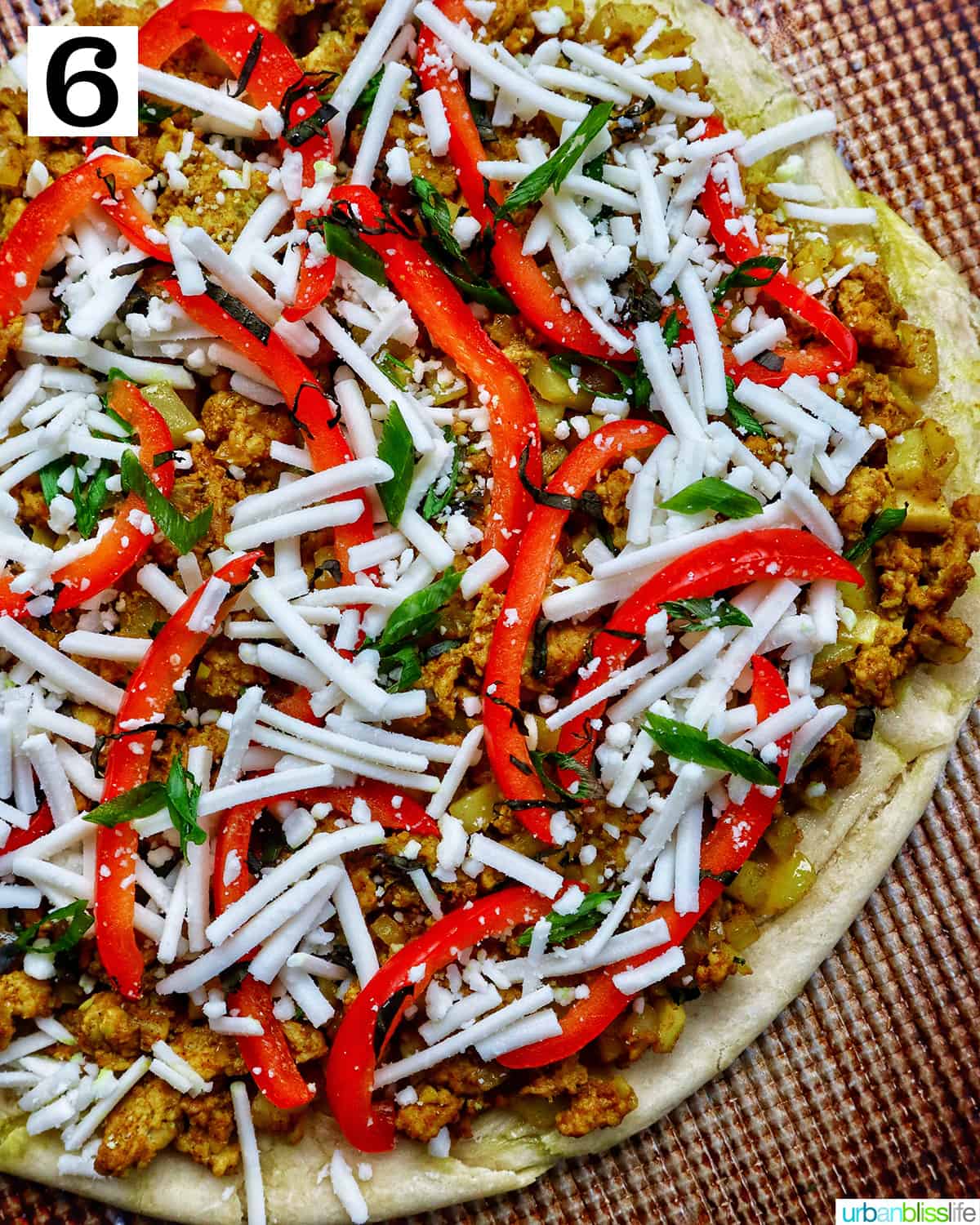 Thai curry pizza on a pizza sheet.