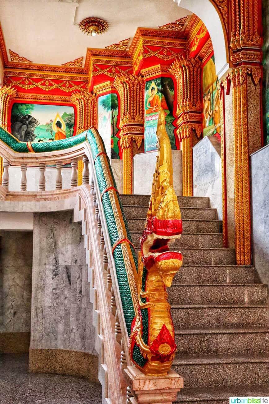 colorful staircase with intricate architectural detail in the prayer hall of Wat Chalong temple in Phuket, Thailand.