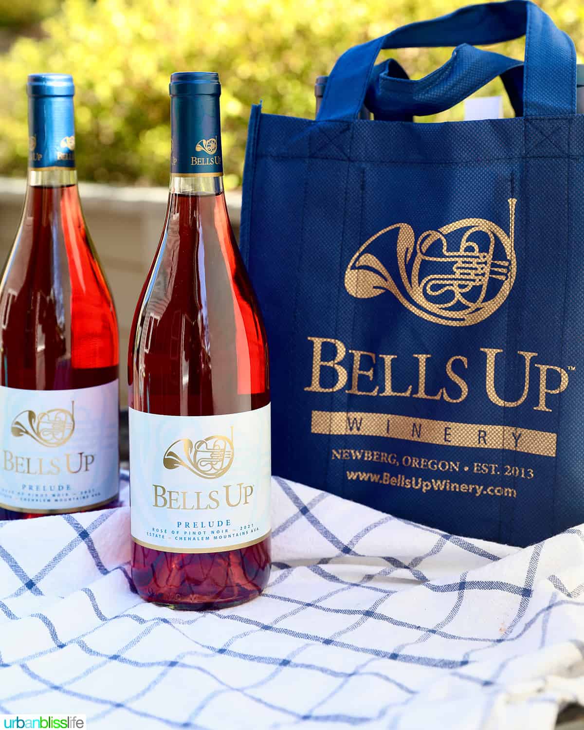 two bottles of Bells Up Winery Rose of Pinot noir with a blue wine bag.