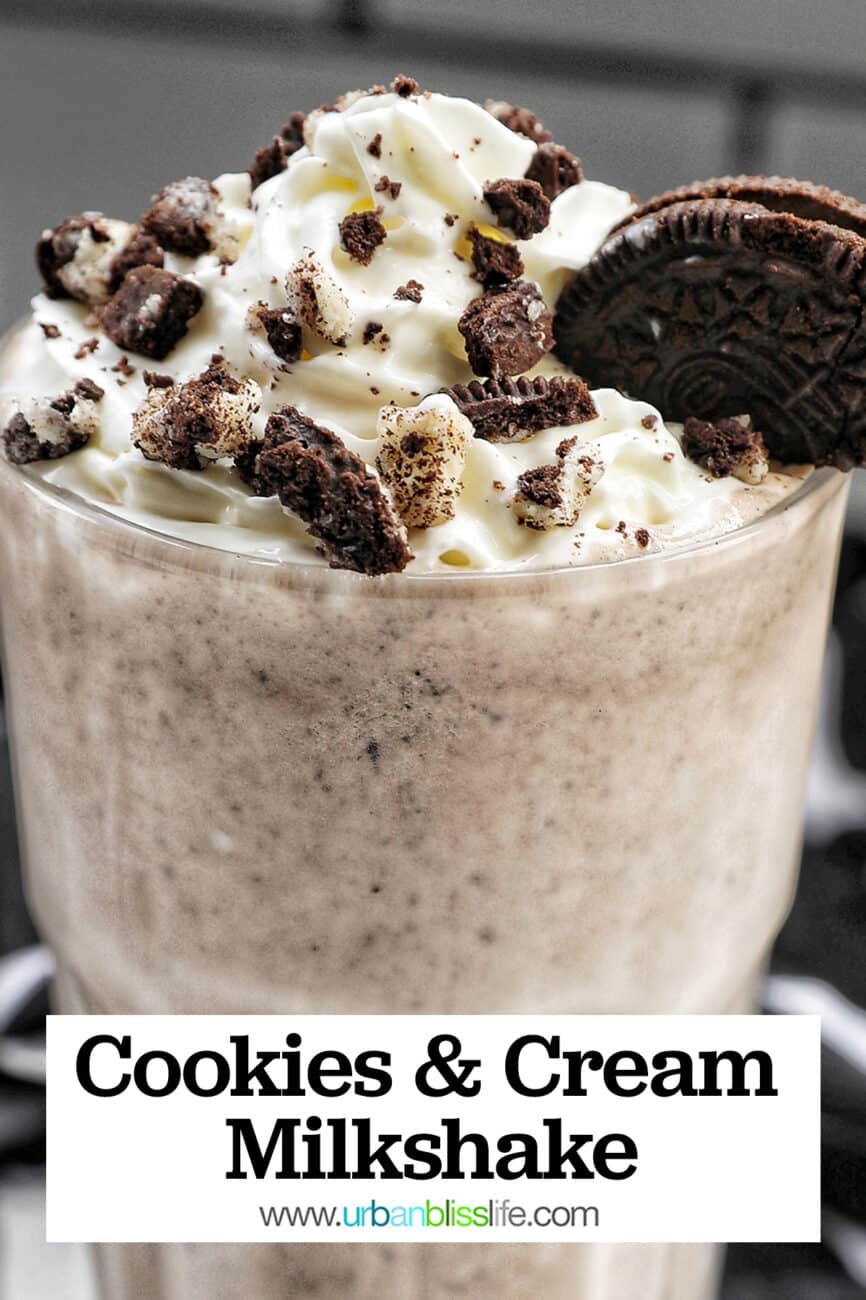 Cookies & Cream Milkshake in a tall glass with whipped cream topping and crushed Oreo cookies on top.
