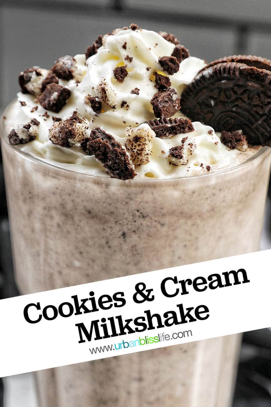 Cookies & Cream Milkshake in a tall glass with whipped cream topping and crushed Oreo cookies on top.