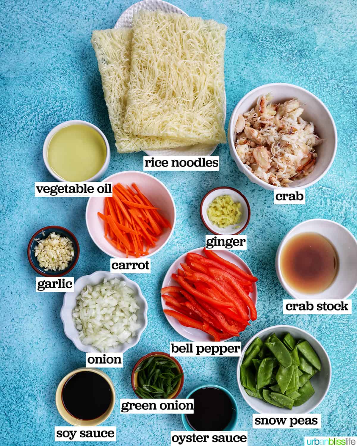 several ingredients in bowls to make crab pancit filipino noodles.