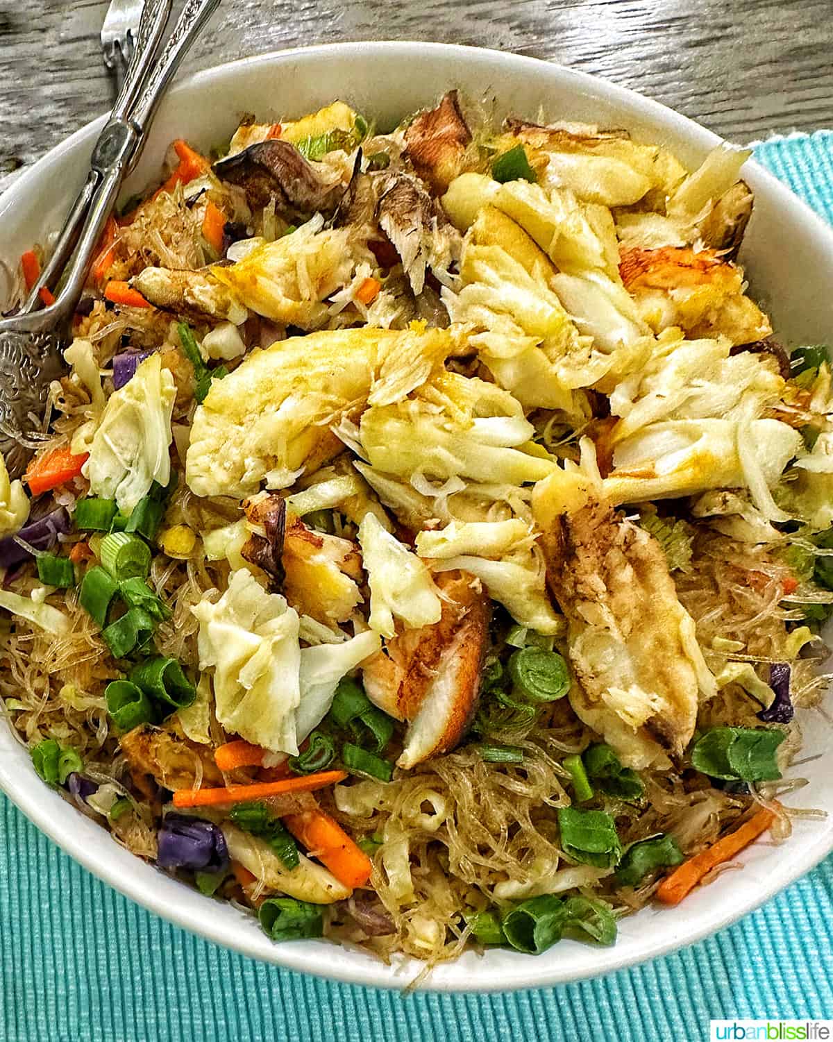 big bowl of crab pansit noodles with veggies and crab meat.