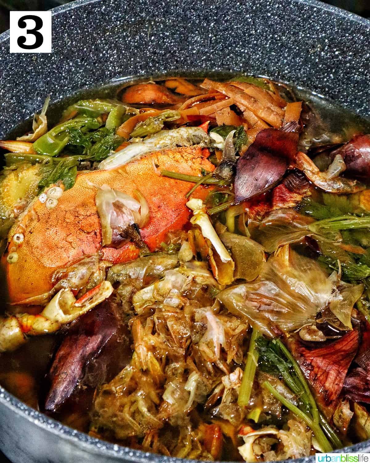 large stockpot with crab stock cooking in it.