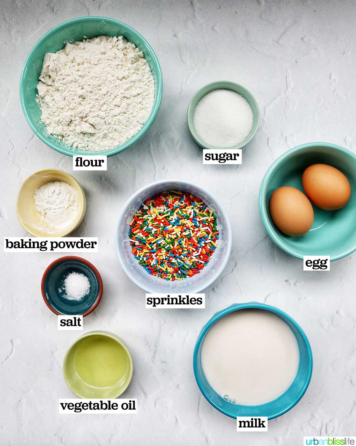 bowls of ingredients to make funfetti pancakes.