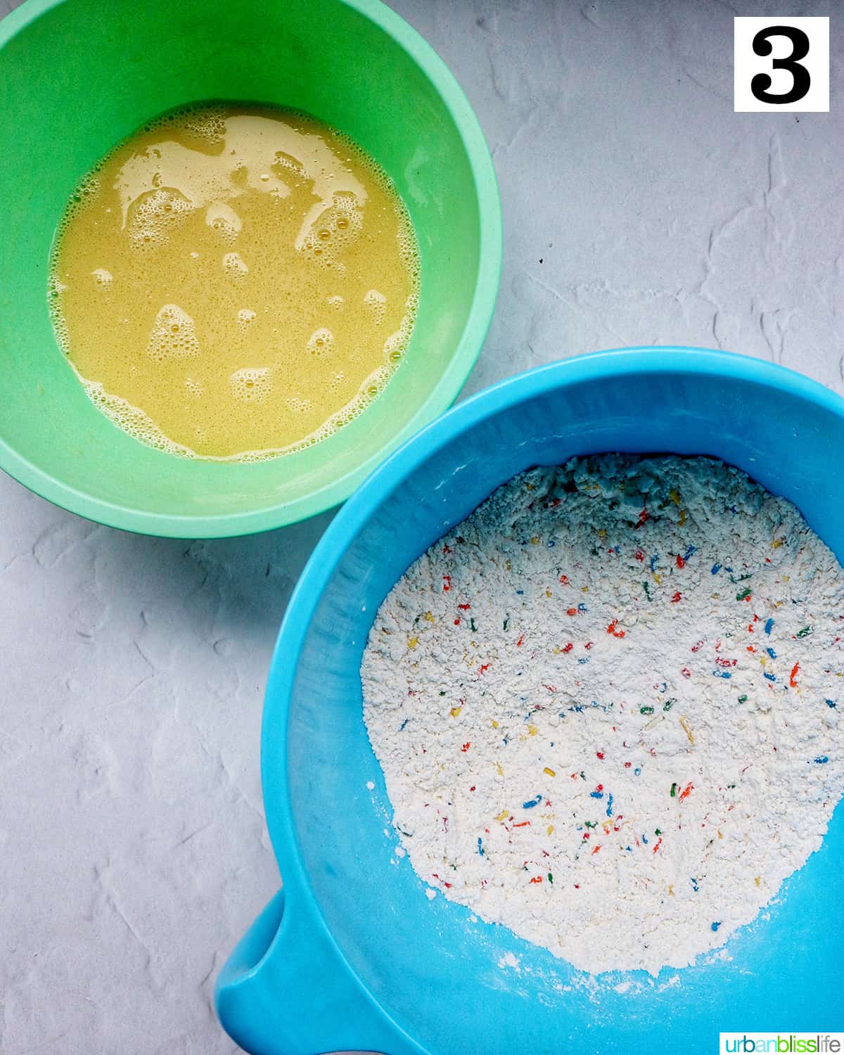 green bowl with wet ingredients next to blue bowl with dry ingredients.