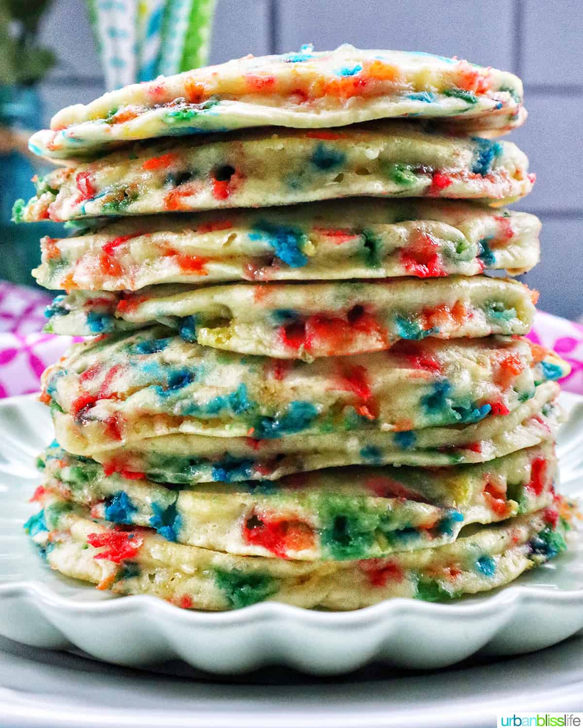 huge stack of funfetti pancakes on a scalloped green plate.