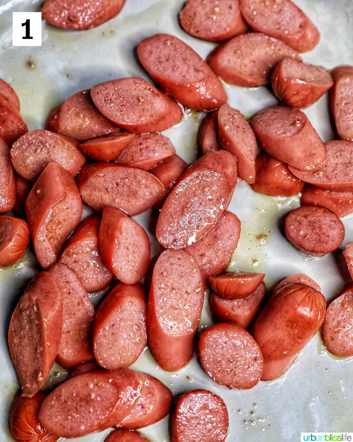 sliced hot dogs in a pan.