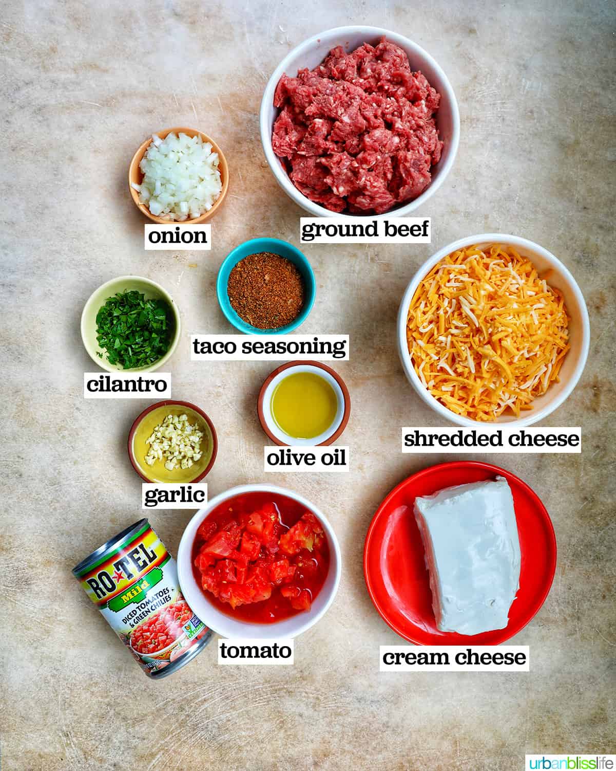 bowls of ingredients to make cheesy taco dip