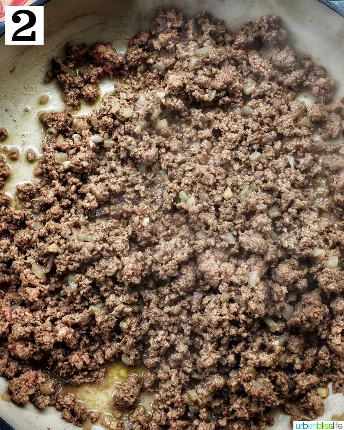 crumbled ground beef cooking in a pan.