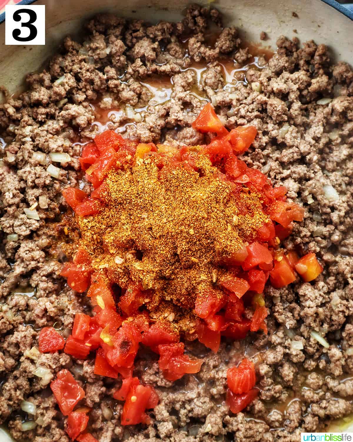 taco seasoning and rotel tomatoes added to ground beef in a pan.
