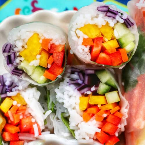 vegan summer rolls cut in half showing the vegetables and vermicelli noodles