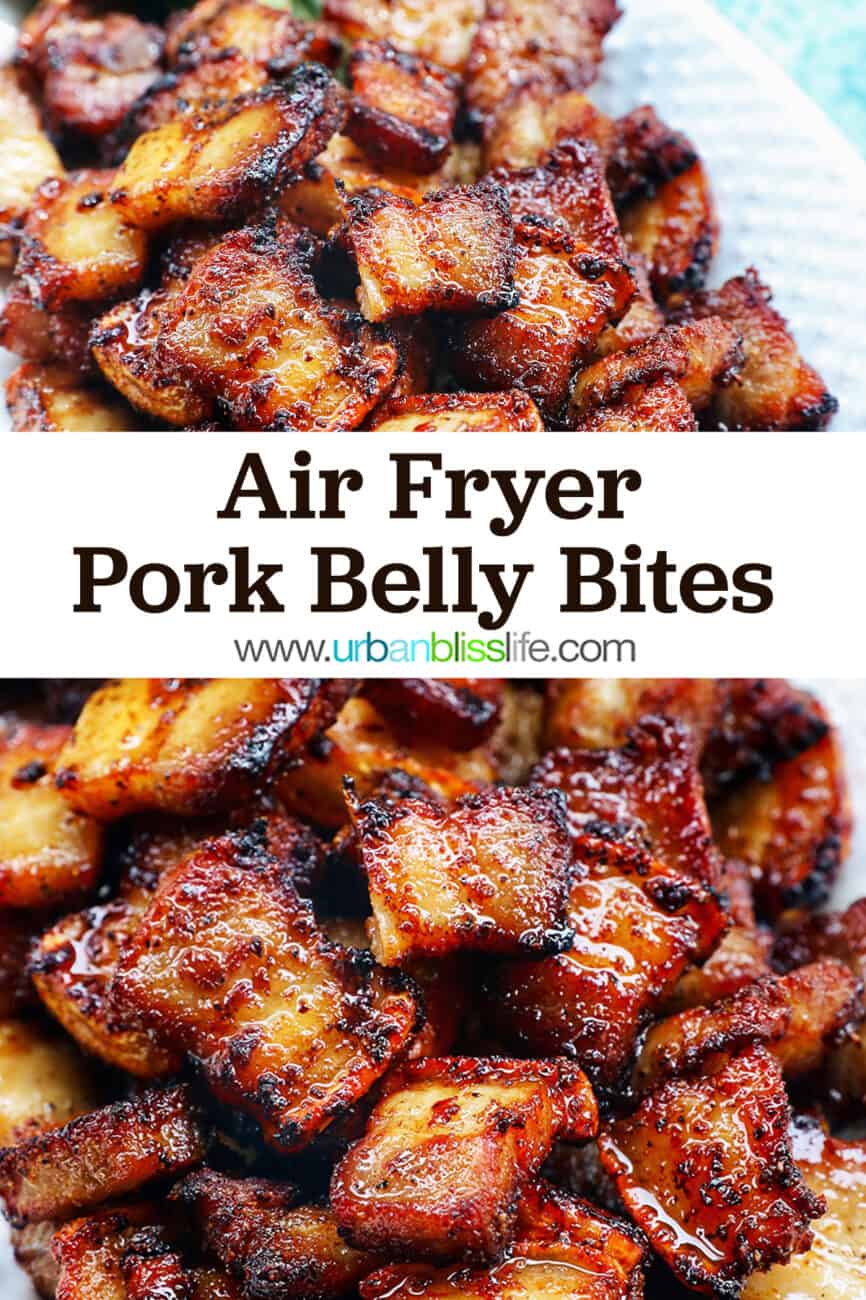 pile of air fryer pork belly bites on a white serving platter with bay leaves on a blue background with title text that reads Air Fryer Pork Belly Bites.