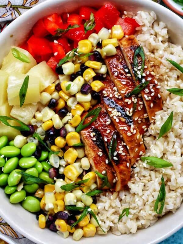 chicken teriyaki donburi bowl with brown rice, teriyaki chicken, corn, edamame, pineapple, red pepper.