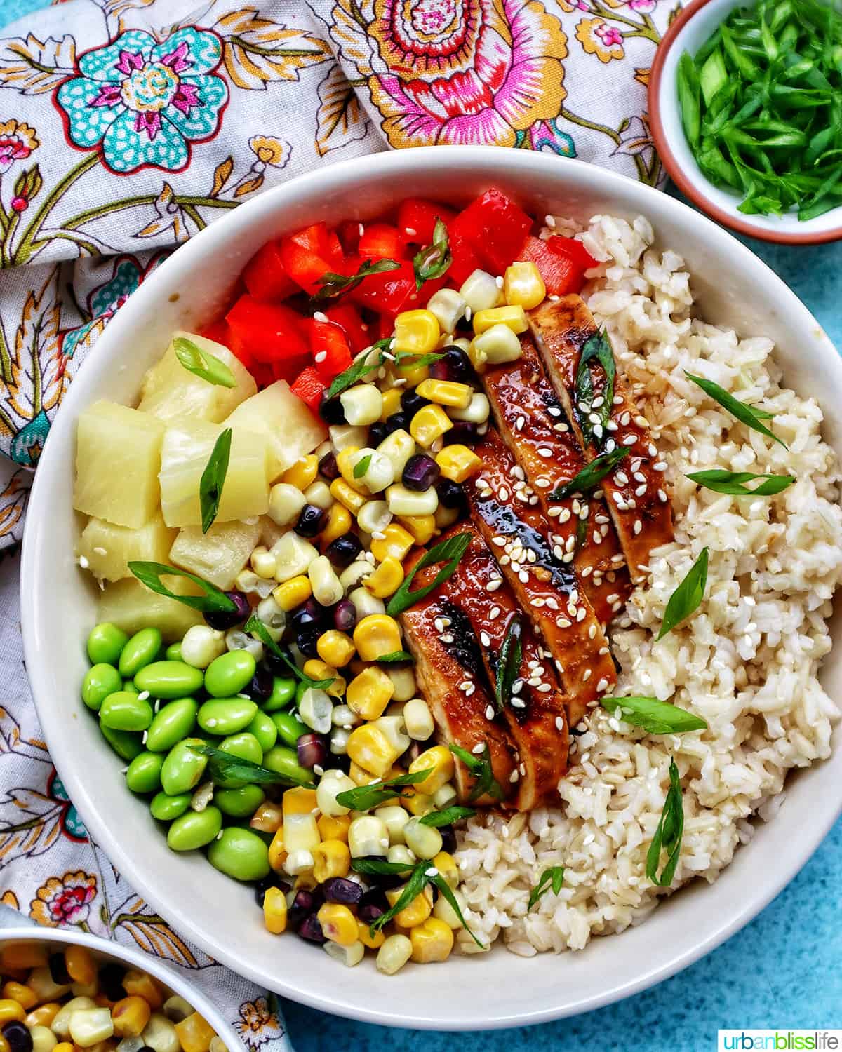 chicken teriyaki donburi  bowl with brown rice, teriyaki chicken, corn, edamame, pineapple, red pepper.