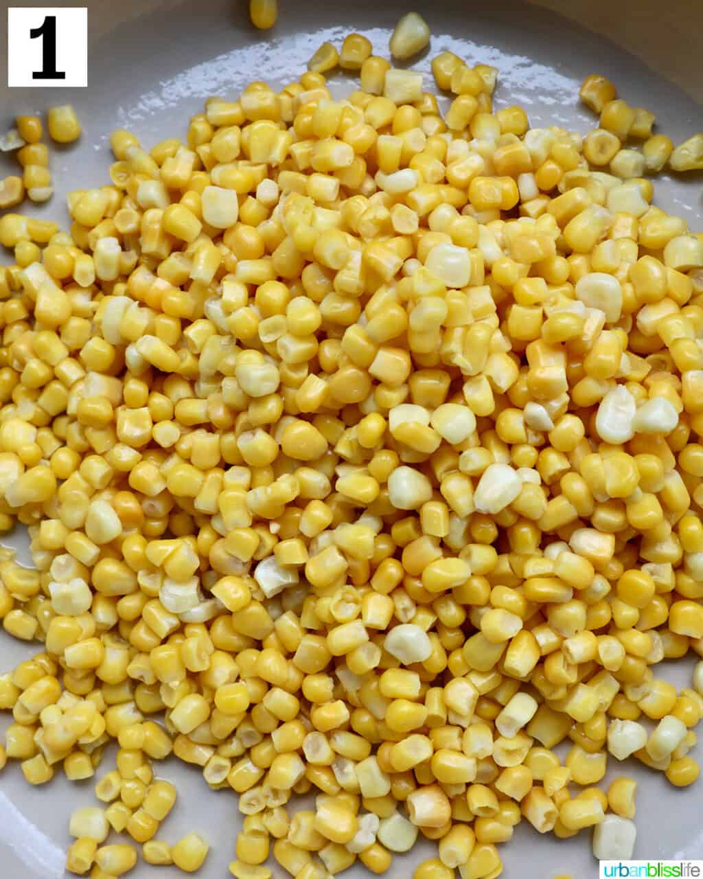 corn kernels cooking in a large saucepan.