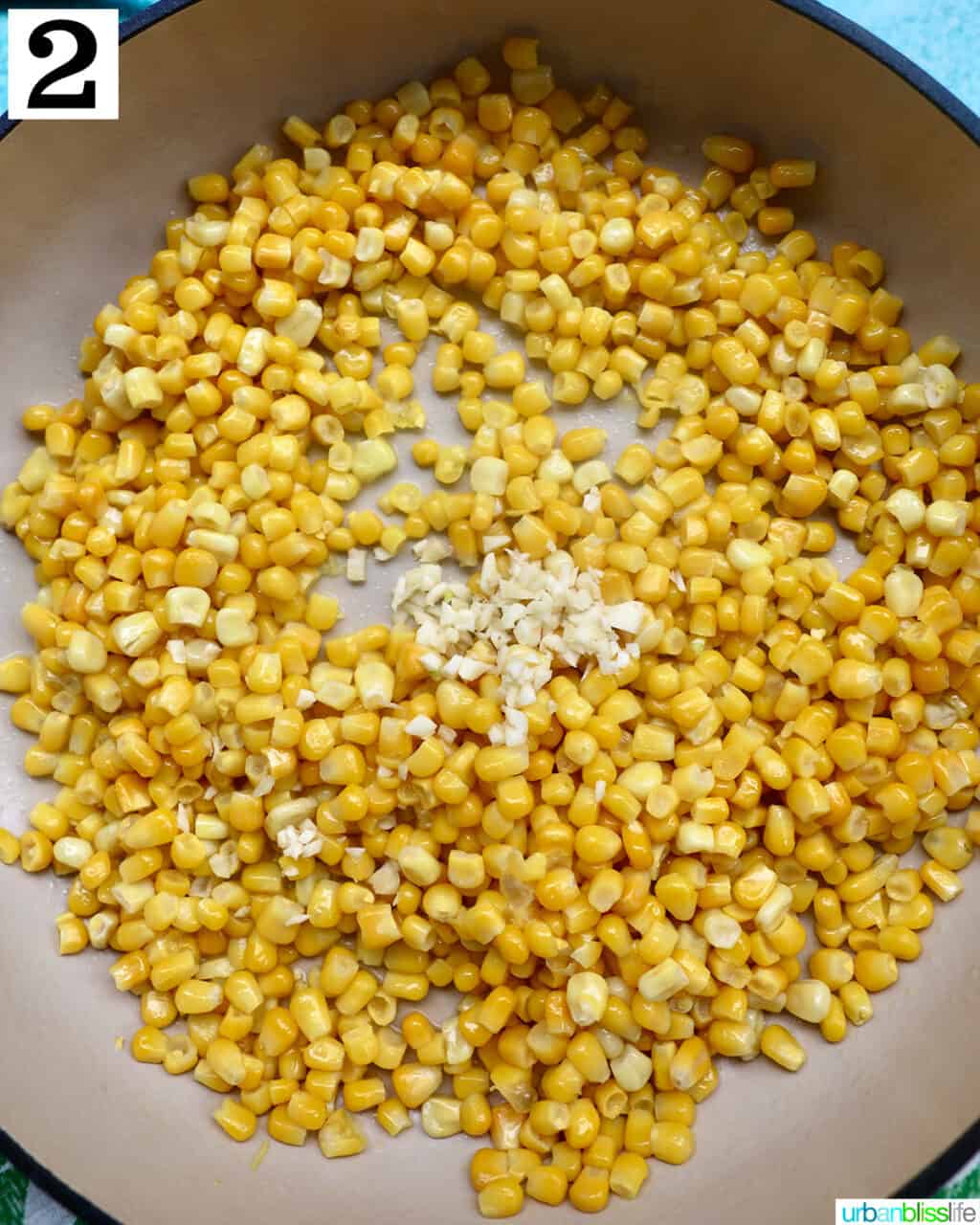 corn kernels and minced garlic cooking in a large saucepan.