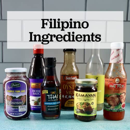 several jars and bottles of Filipino ingredients used in Filipino cuisine on a blue table with text that reads Filipino Ingredients.