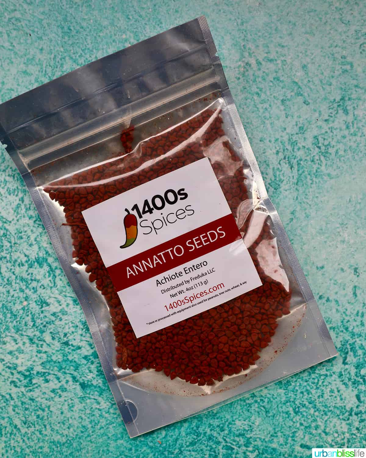 packet of annatto seeds on a blue background.