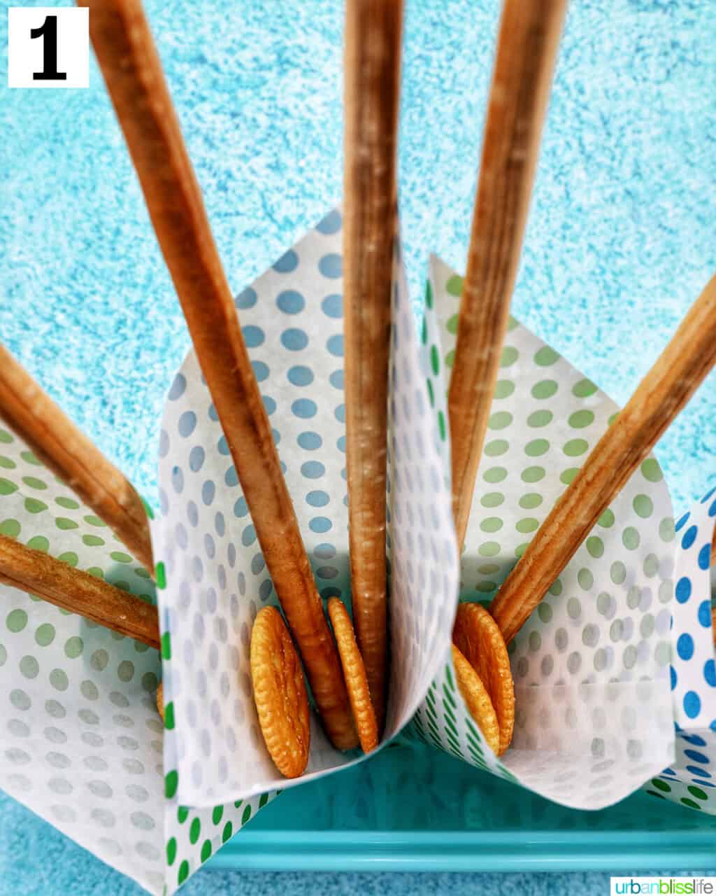 paper cones with breadsticks and crackers inside.
