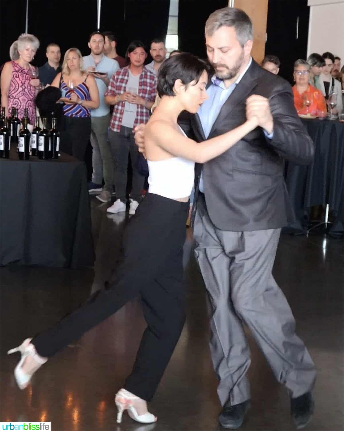 Tango with Adam dancers dancing in front of a crowd.