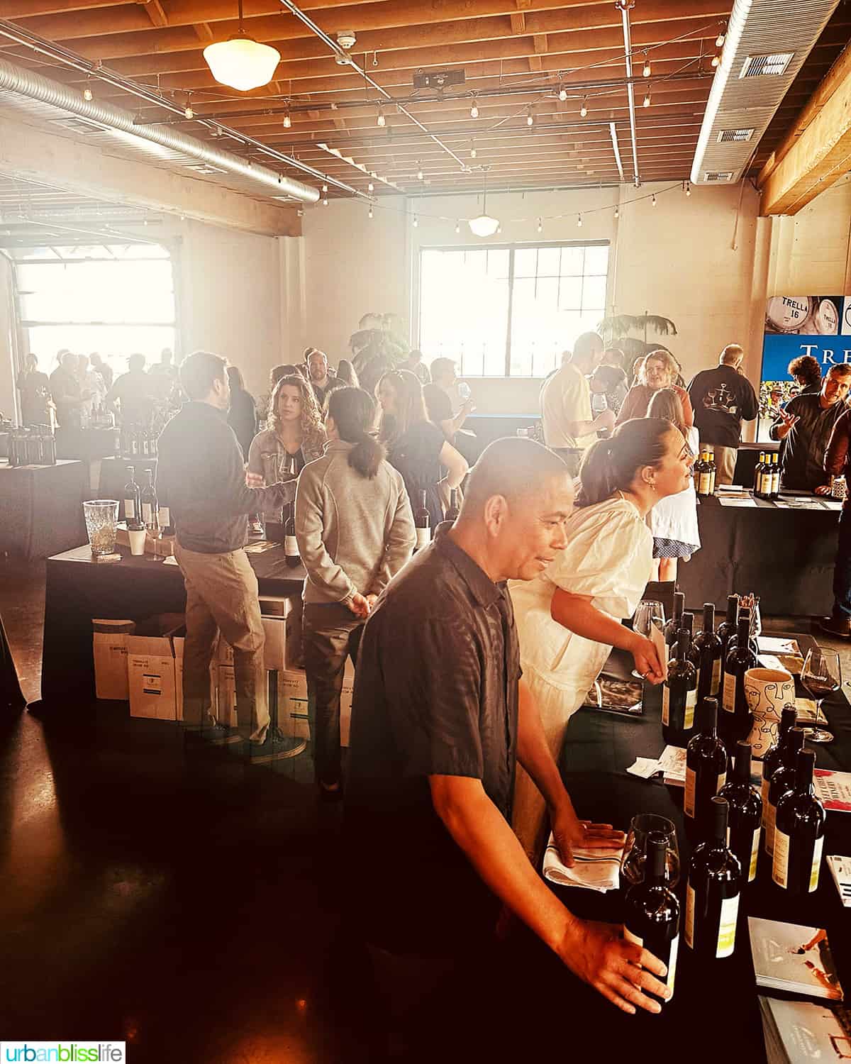 winemaker of Sweet Cheeks Winery at the Malbec in the city table with crowd.