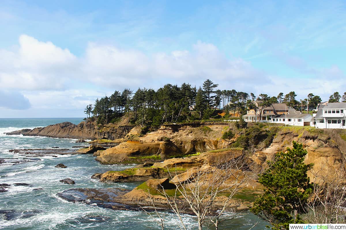 Depoe Bay, Oregon - photo of waves against the shore and a large white building overlooking the ocean.