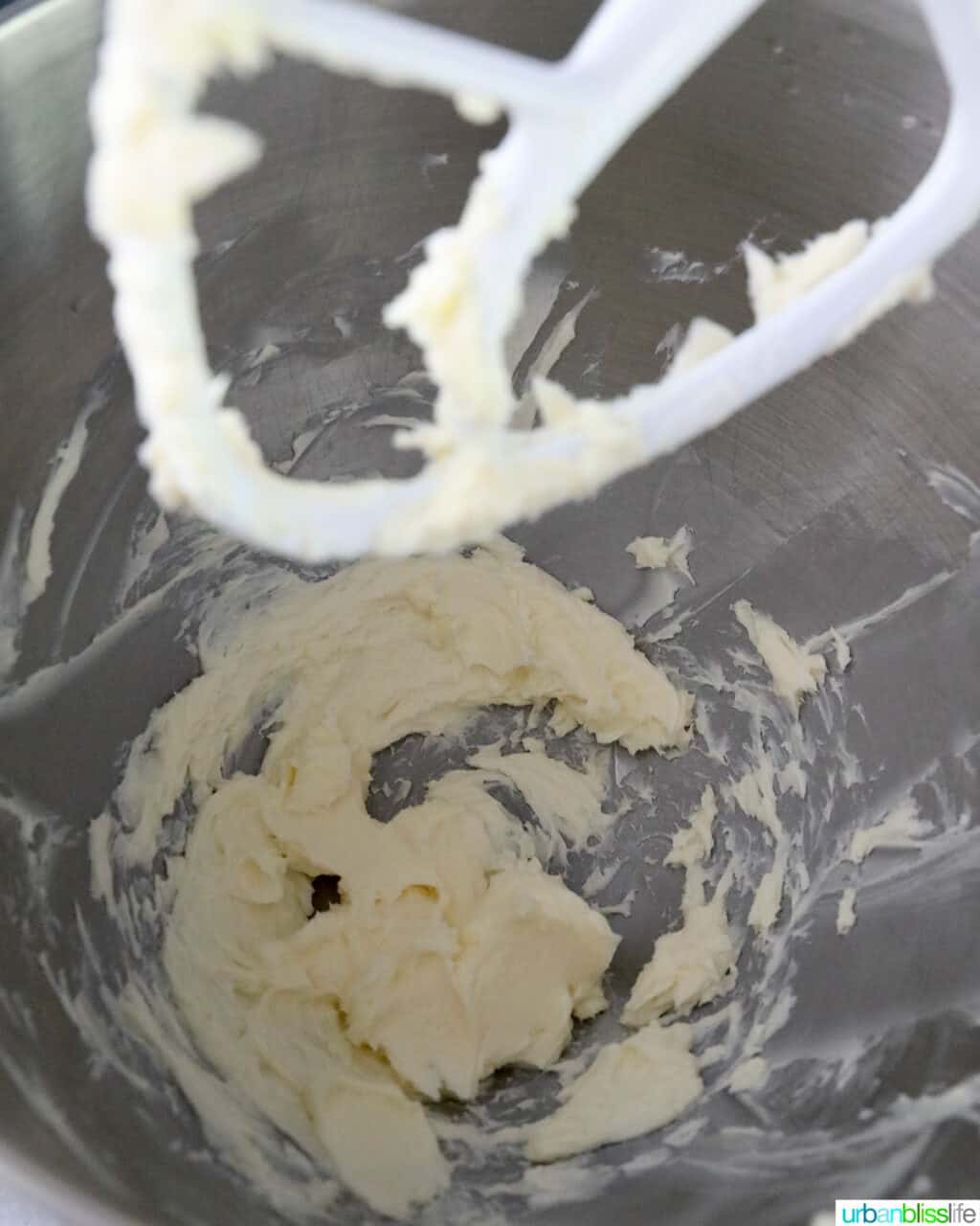 butter creamed in a stainless steel stand mixer bowl with paddle attachment.