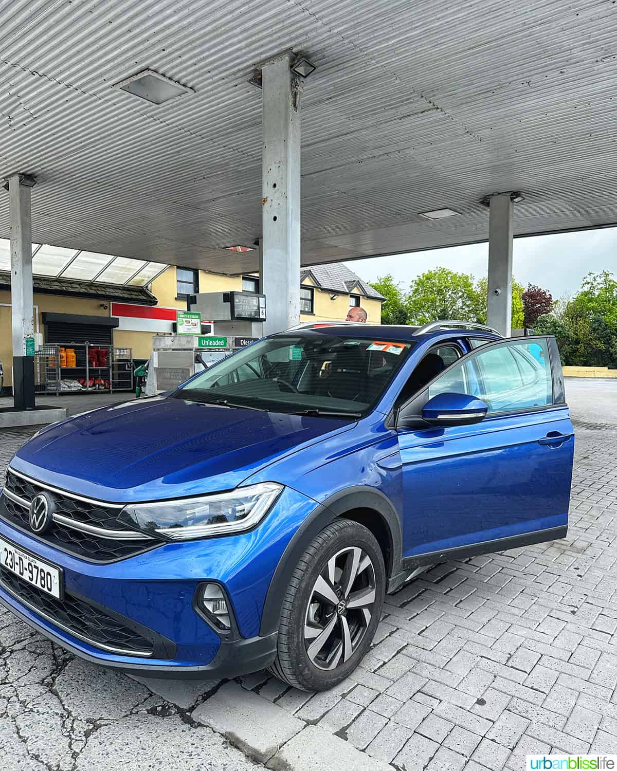 blue volkswagen tiago at gas station