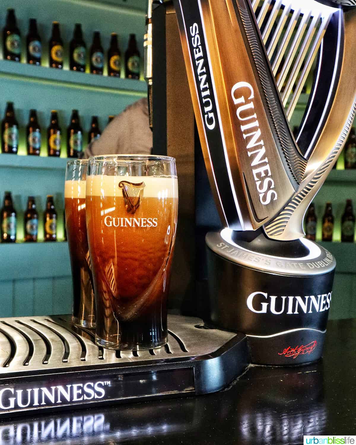 two glasses of guinness beer and harp and guinness storehouse in dublin