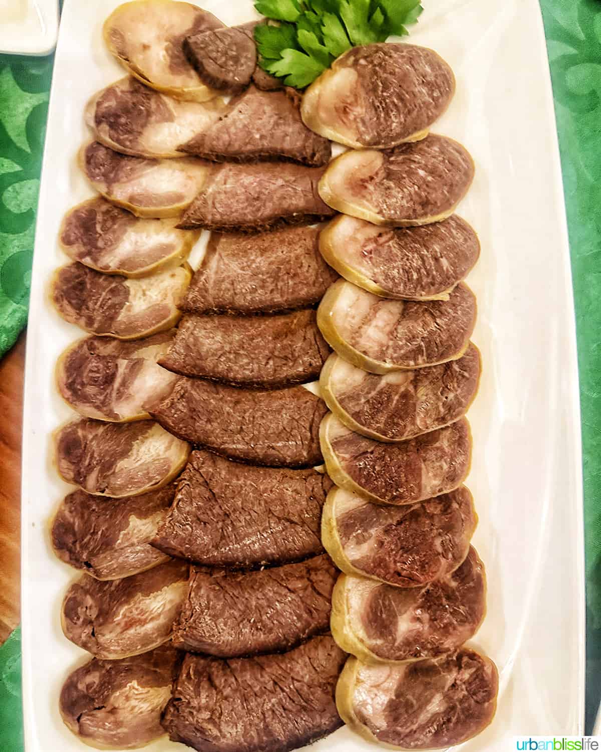 white platter full of kazy, a boiled horse meat sausage sliced, popular dish in Kazakhstan.