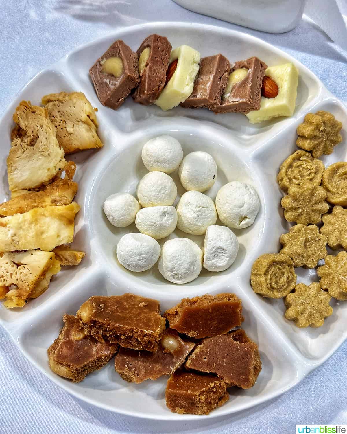 round tray of various Kazakhstan desserts including kurt.