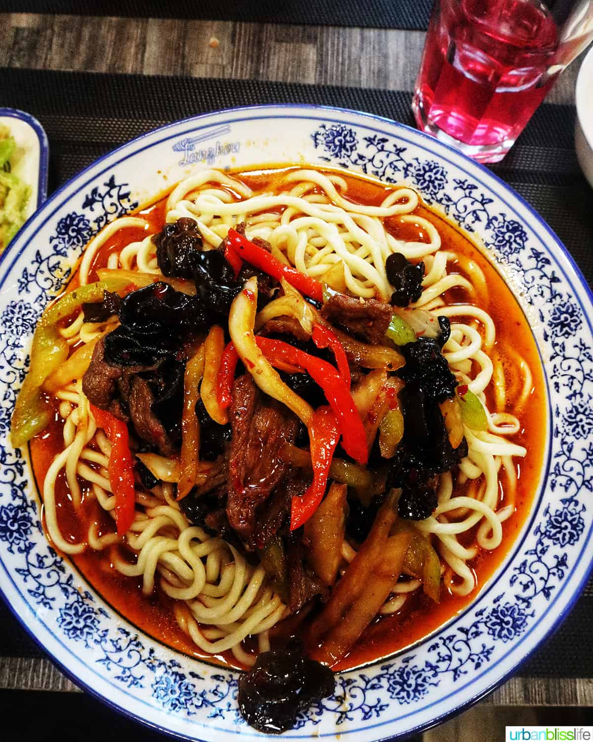 ornate blue and white bowl of Lagman noodles in Kazakhstan.