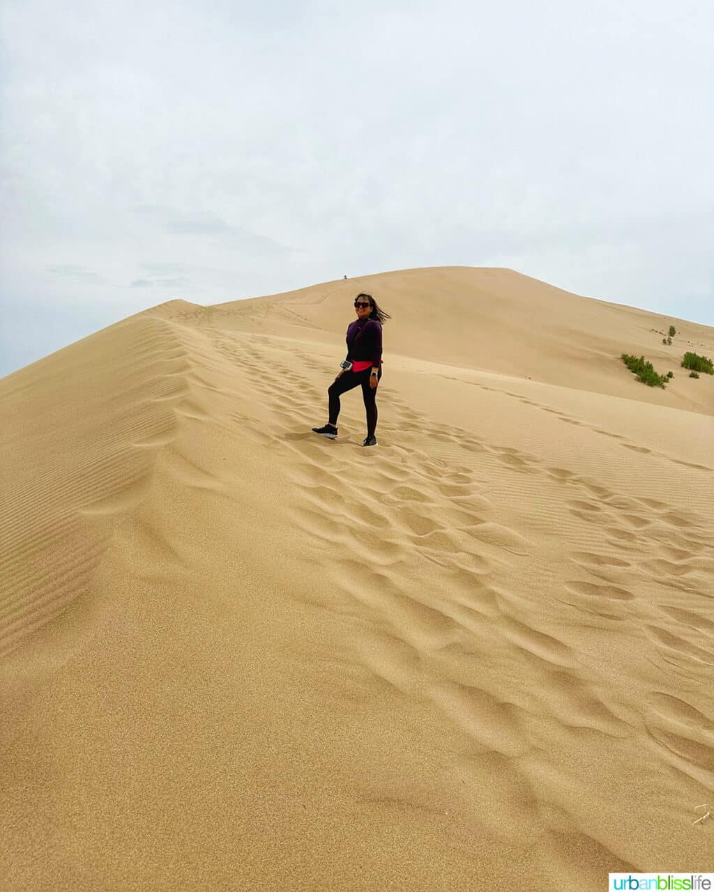 Marlynn Jayme Schotland climbing the Singing Dunes of Altyn-Emel National Park in Almaty, Kazakhstan.