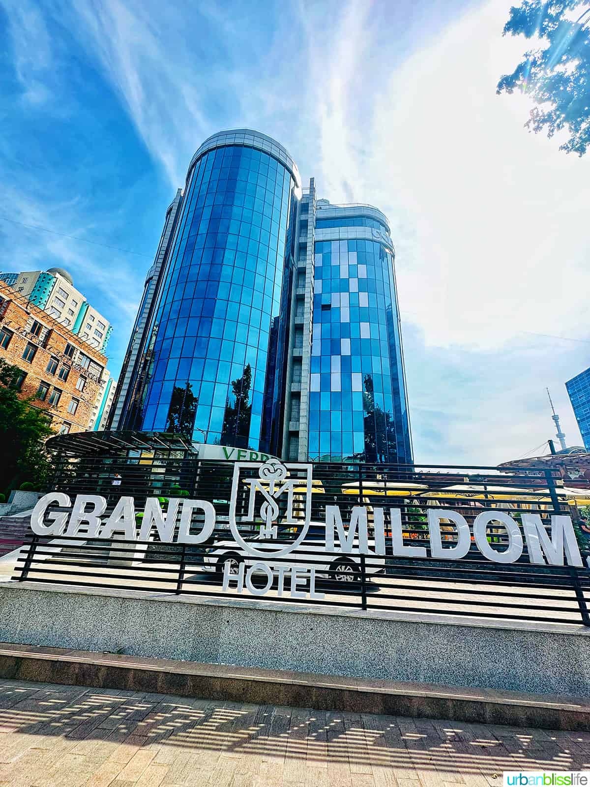 front exterior and sign of Grand Mildom hotel in Almaty, Kazakhstan.