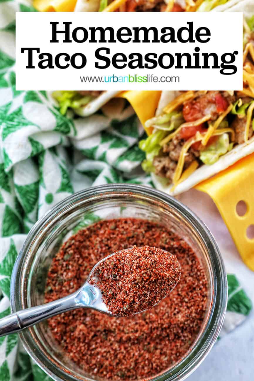 two tacos in a taco stand next to a jar of homemade mild taco seasoning with title text.