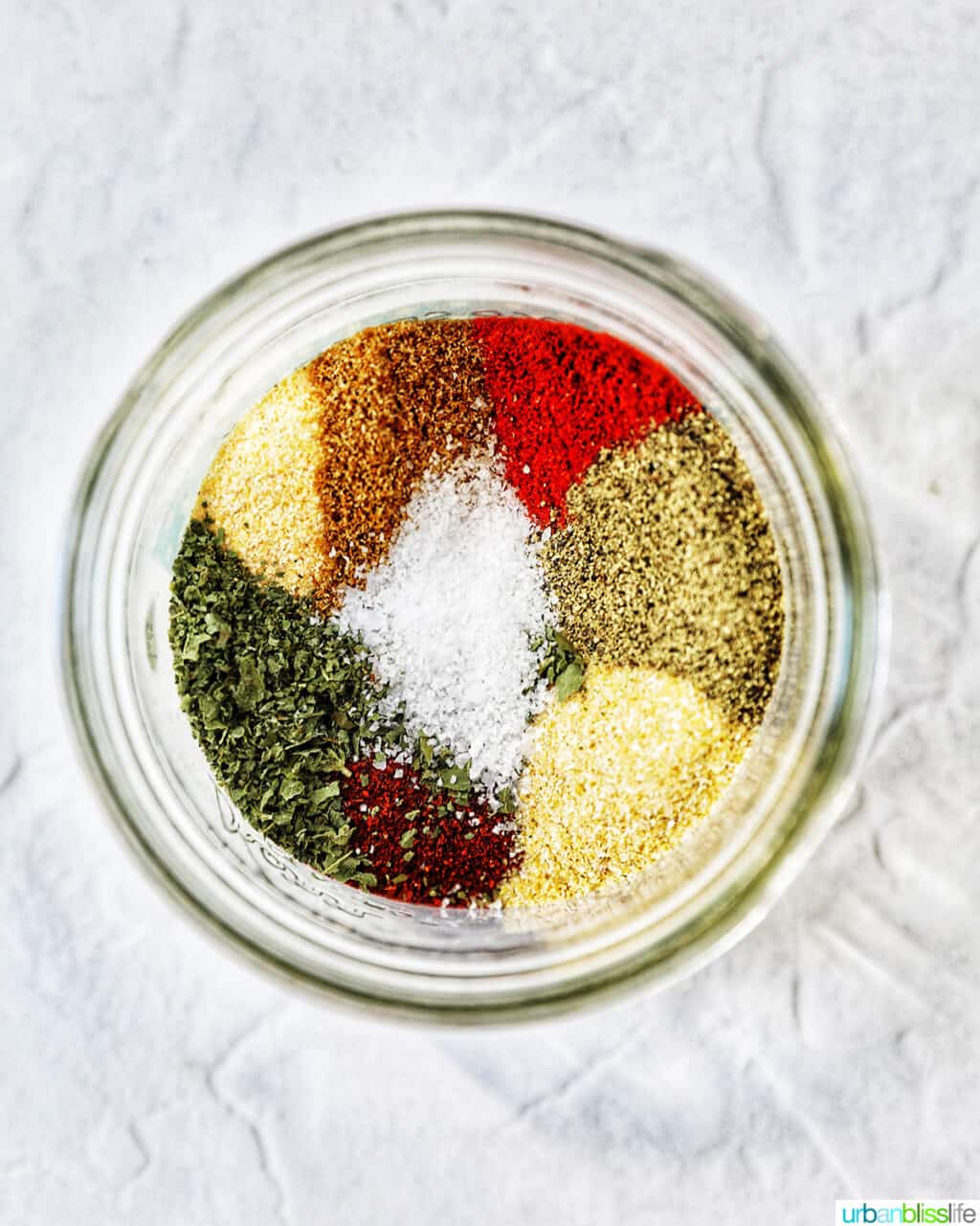 overhead looking inside a jar of spices to make homemade mild taco seasoning.