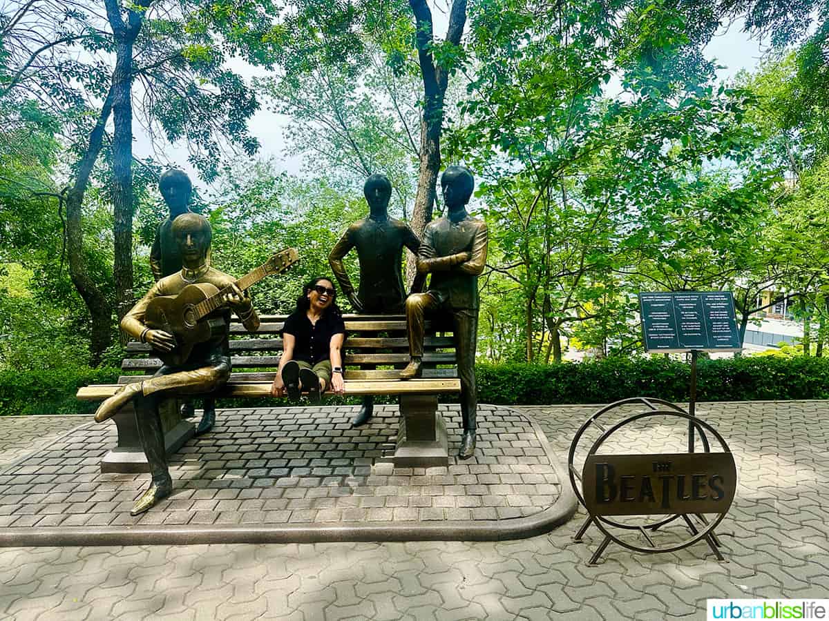 Marlynn Jayme Schotland sitting on the bench of the Beatles monument in Kok Tobe hill in Almaty Kazakhstan.