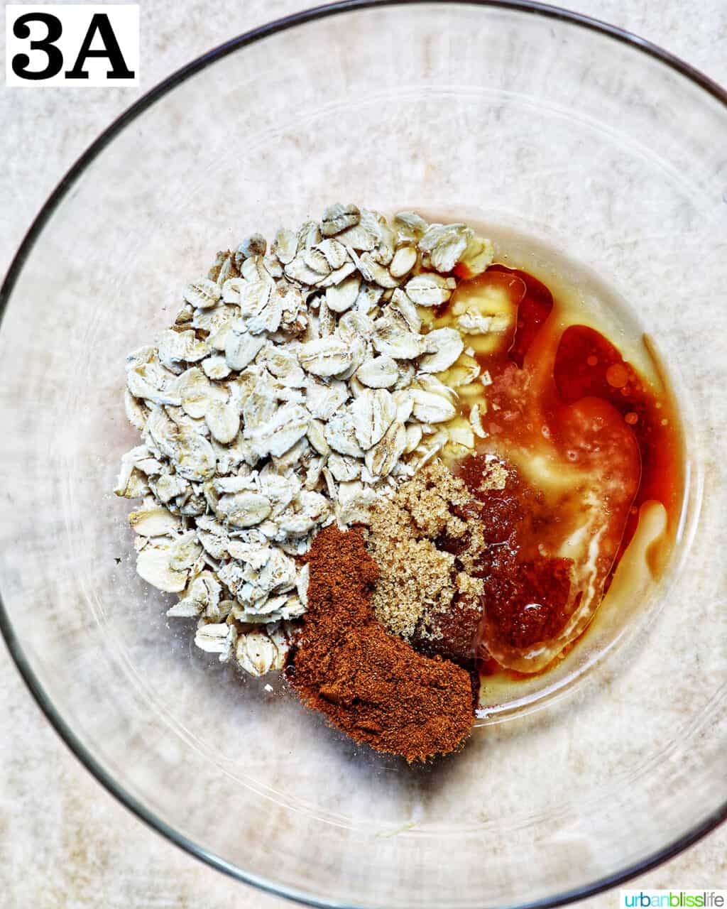 clear glass bowl with ingredients to make a cinnamon oats topping.