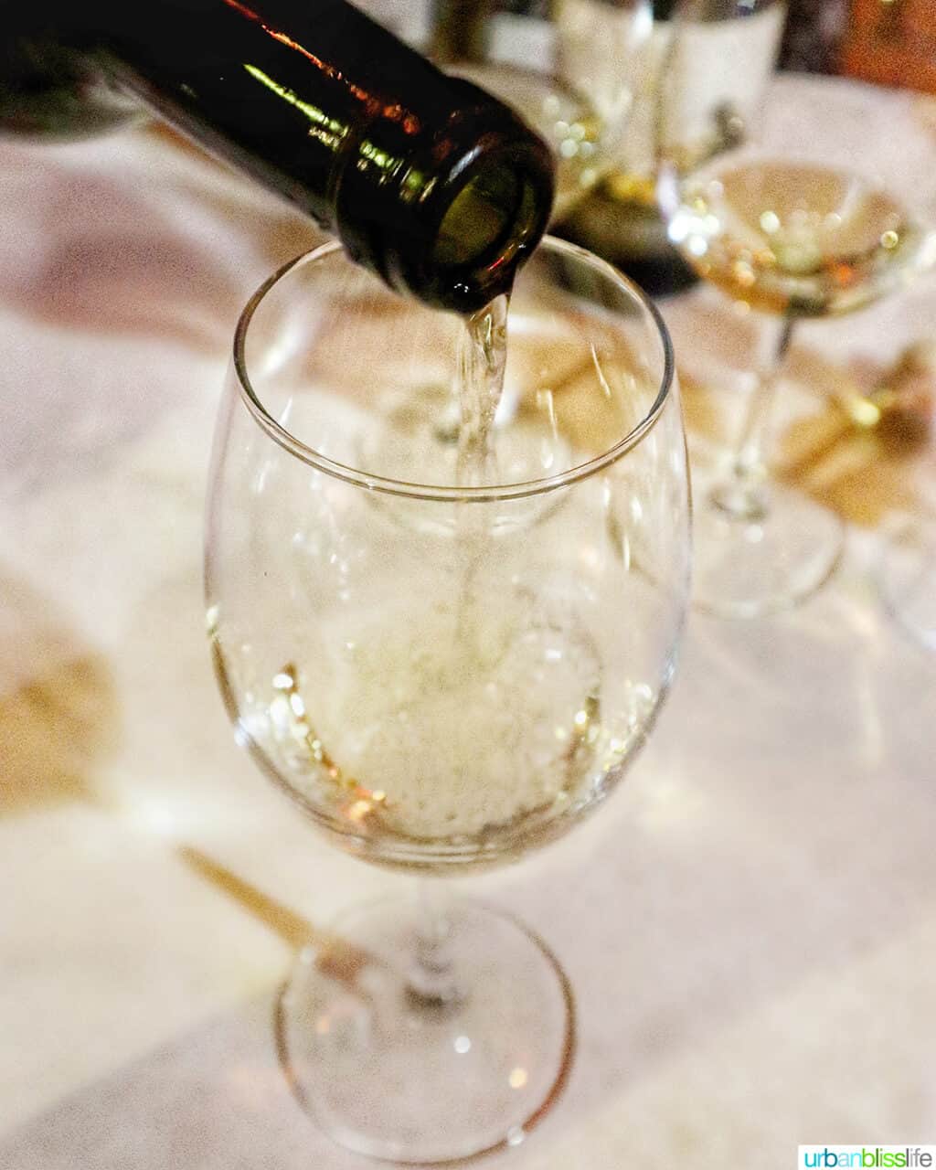 pouring a white Kazakhstan wine into a glass.