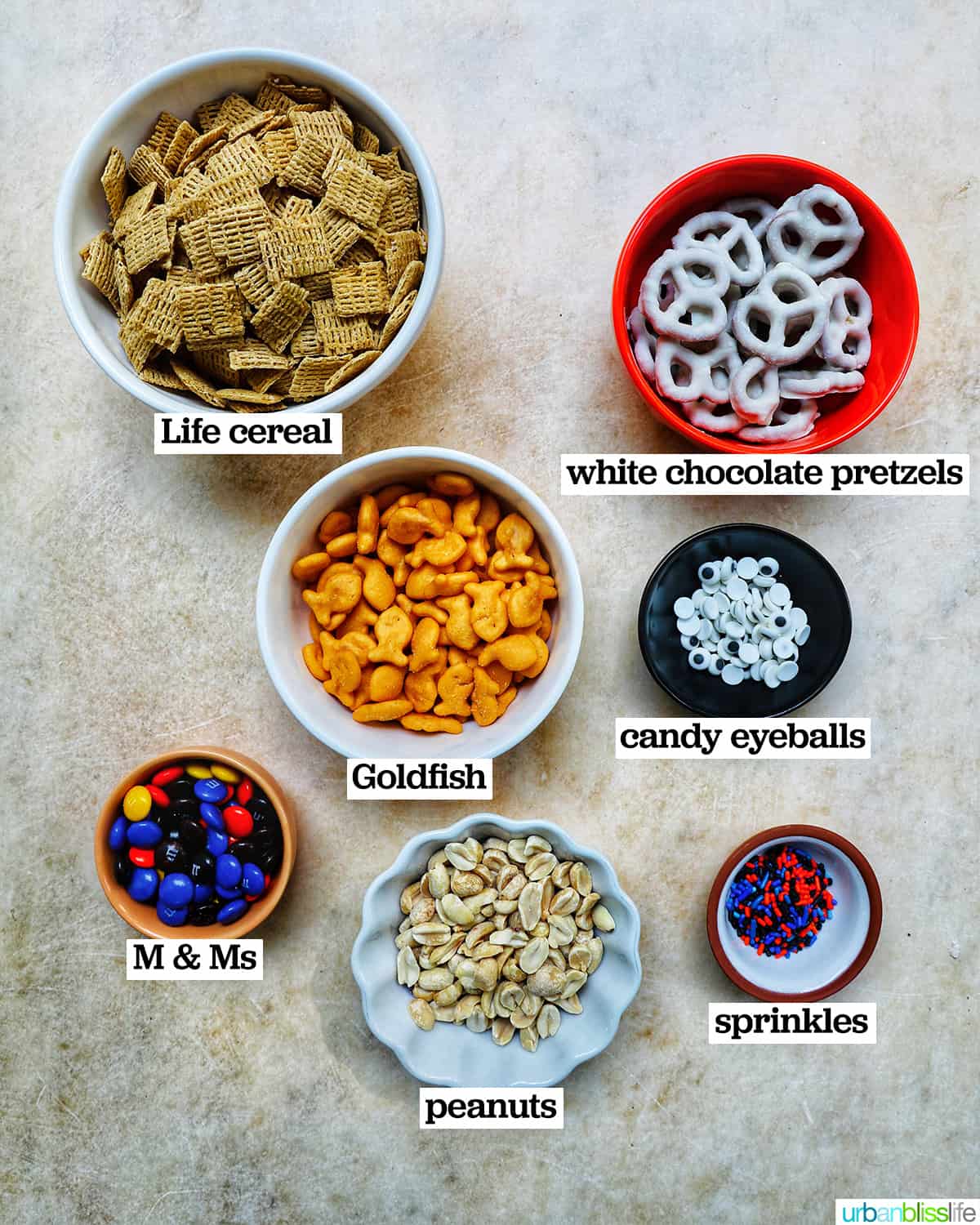 bowls of ingredients to make Halloween Snack Mix.