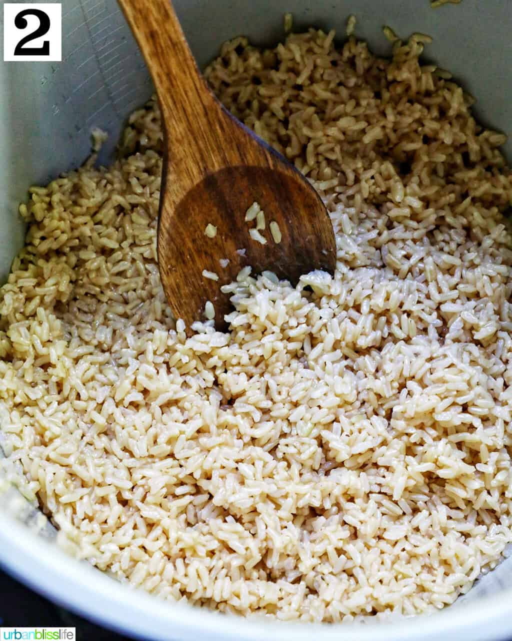 wooden spoon fluffing up chipotle brown rice in the instant pot.
