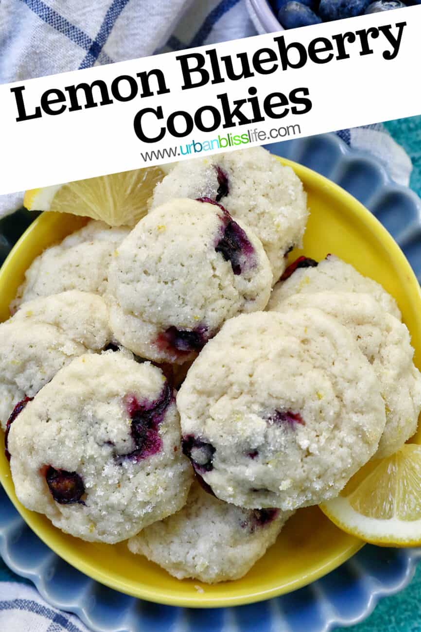 lemon blueberry cookies on a yellow and blue plate with lemon slices with title text that reads "Lemon Blueberry Cookies."